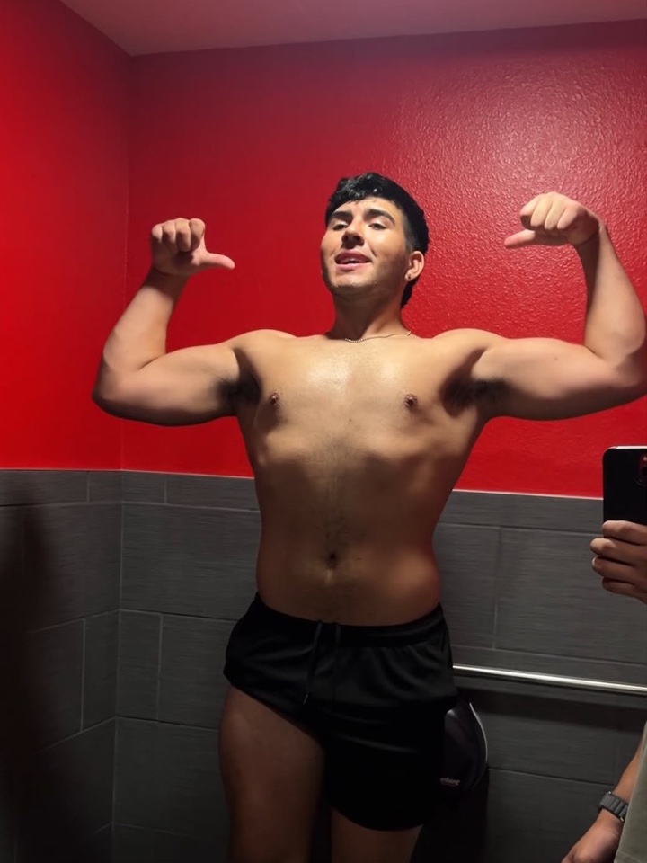 Earlier physique photo in a red-walled locker room
